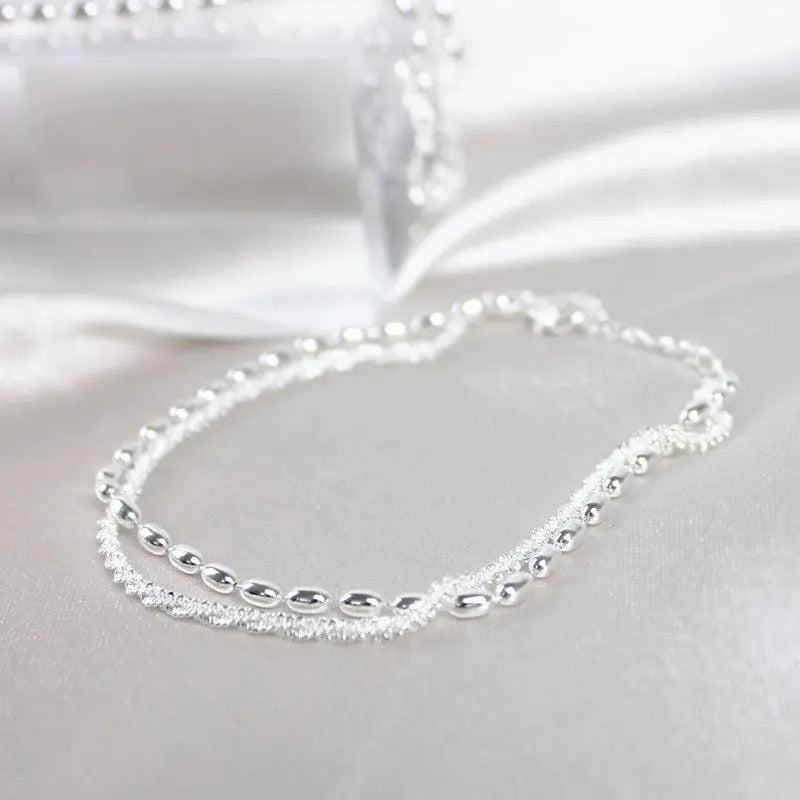 Elegantes set de pulsera de color plata con piedras de circonio
