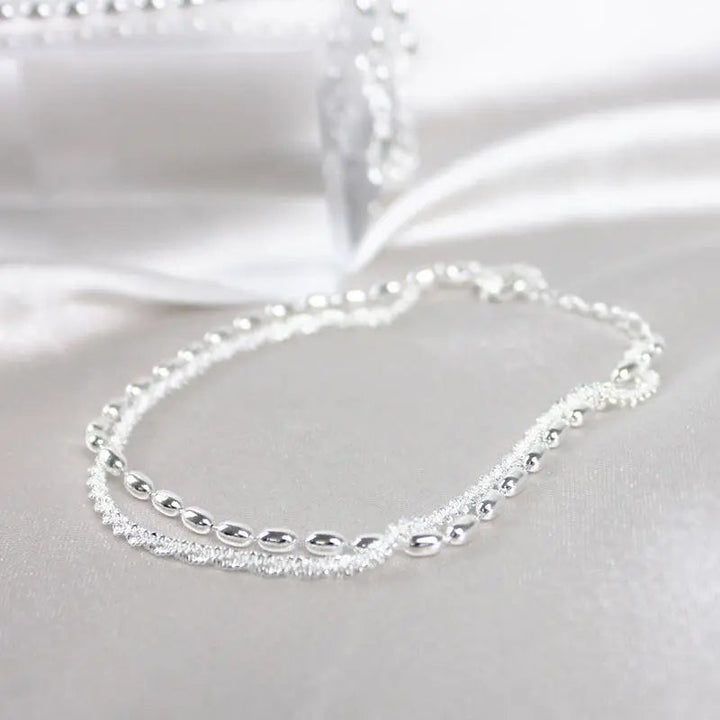 Elegantes set de pulsera de color plata con piedras de circonio