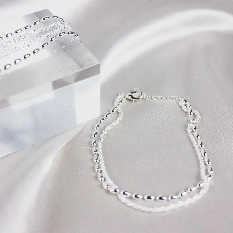 Elegantes set de pulsera de color plata con piedras de circonio
