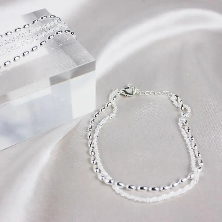 Elegantes set de pulsera de color plata con piedras de circonio