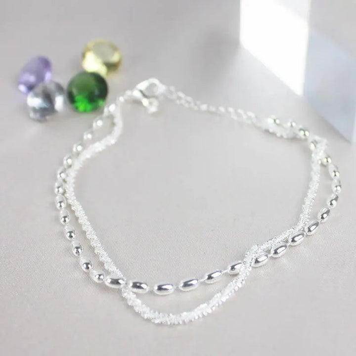 Elegantes set de pulsera de color plata con piedras de circonio