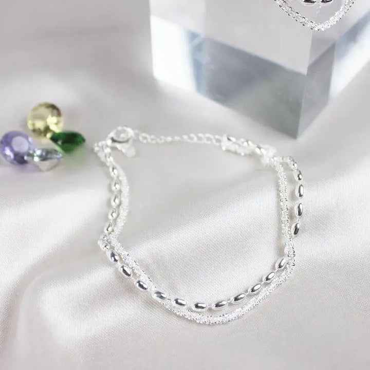 Elegantes set de pulsera de color plata con piedras de circonio