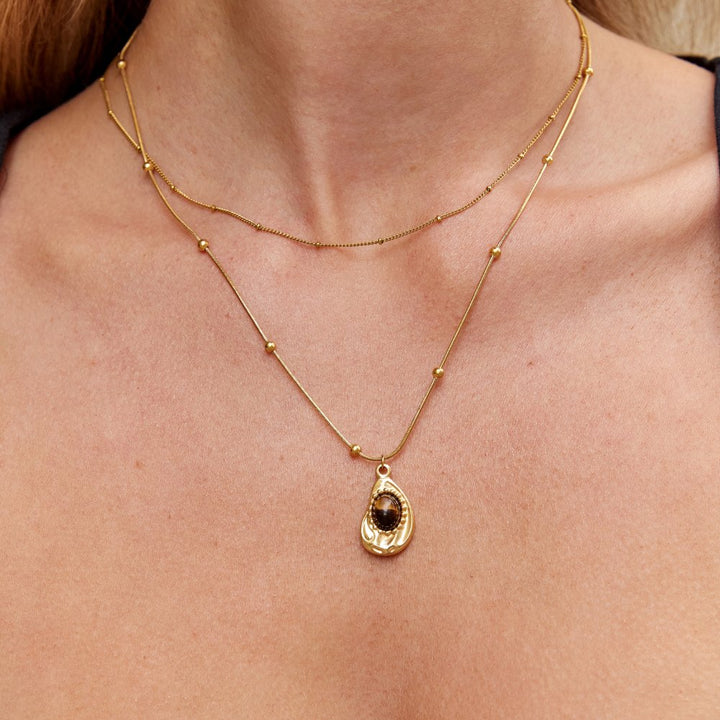 Elegante collar de color oro con piedra ojo de tigre